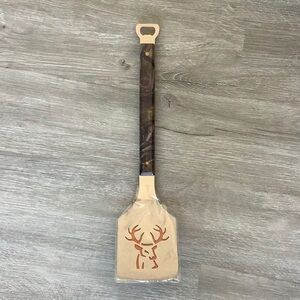 The Sportula camouflage buck spatula with bottle opener end